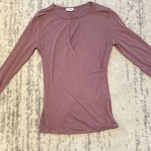 Tight fitted, magenta, long sleeve shirt.